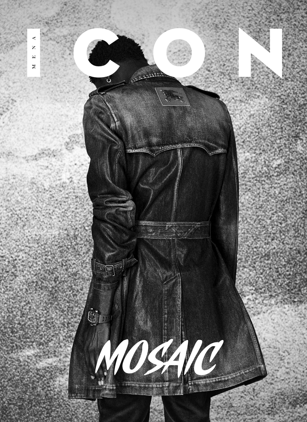 ICON MENA cover: a model seen from behind in a distressed denim trench against an engraved sky