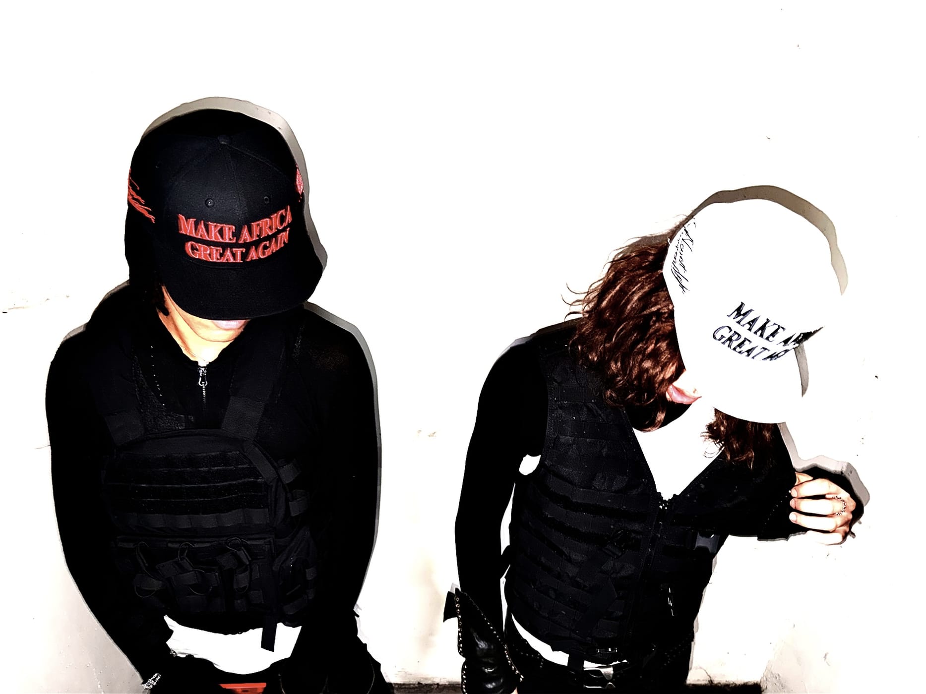 Two figures in plate carriers, faces hidden under the red and the white cap